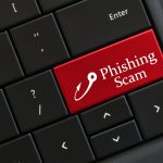 Beware of Phishing Scam Emails - Concept - Computer Keyboard with red key that says PHISHING SCAM